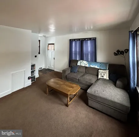 a living room with furniture and a lamp