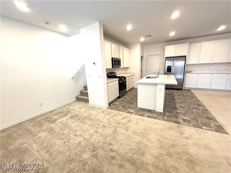 8336 Rowan Rdg Avenue Las Vegas, NV 89147 - Photo 5 of 15 This open concept living area seamlessly connects the kitchen and living room for effortless flow.