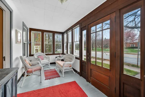 a living room with furniture and floor to ceiling windows