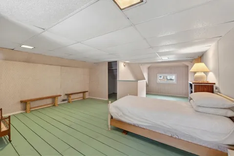 a bedroom with a bed and a window