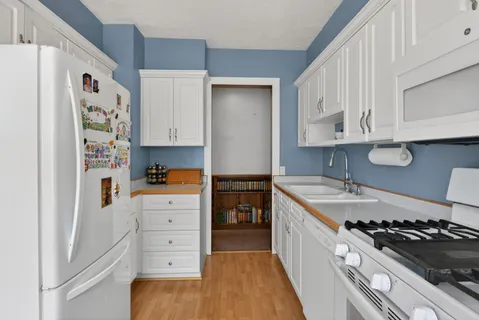 a kitchen with stainless steel appliances granite countertop a stove and a refrigerator