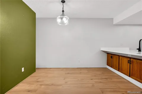 a view of a room with wooden floor and chandelier