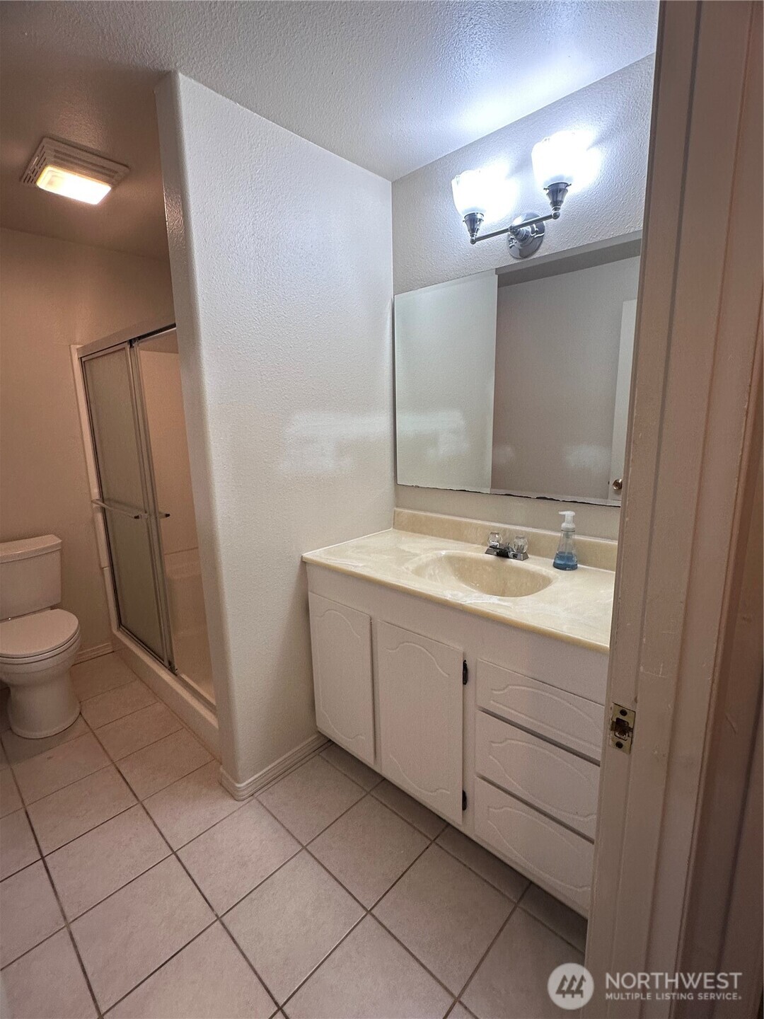 1301 South 3rd Avenue, Unit 7D Sequim, WA 98382 - Photo 11 of 32 a bathroom with a double vanity sink a toilet and a mirror
