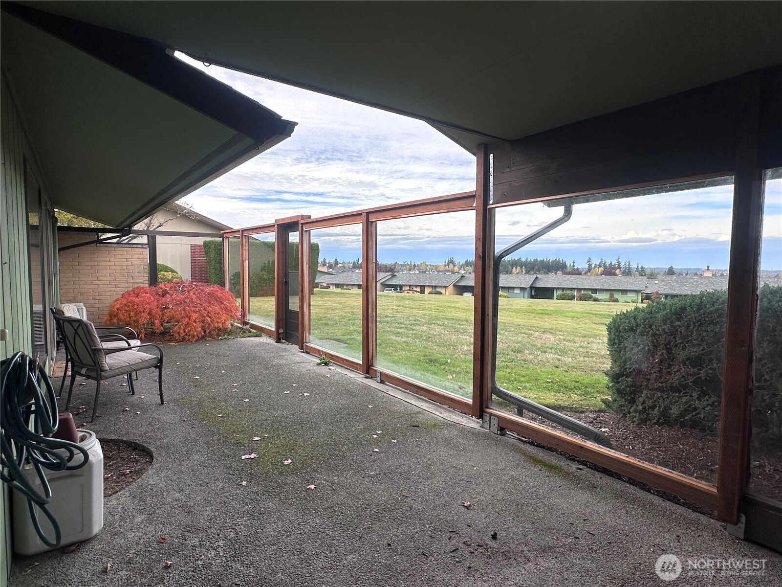 1301 South 3rd Avenue, Unit 7D Sequim, WA 98382 - Photo 29 of 32 a view of a room with table and chairs next to a yard