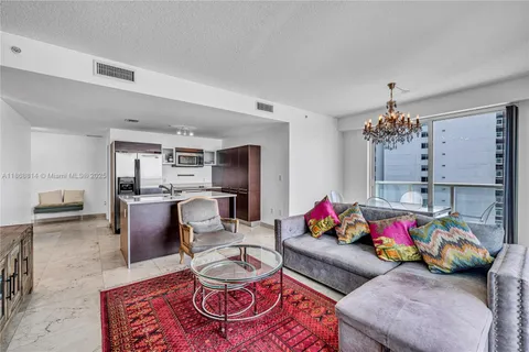 a living room with furniture and a chandelier