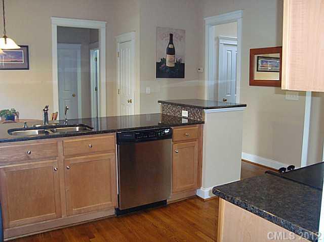 6169 Caseys Side Way Fort Mill, SC 29708 - Photo 3 of 13 a kitchen with granite countertop a sink and a stove top oven