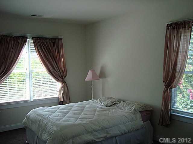 6169 Caseys Side Way Fort Mill, SC 29708 - Photo 8 of 13 a bedroom with a bed and a window