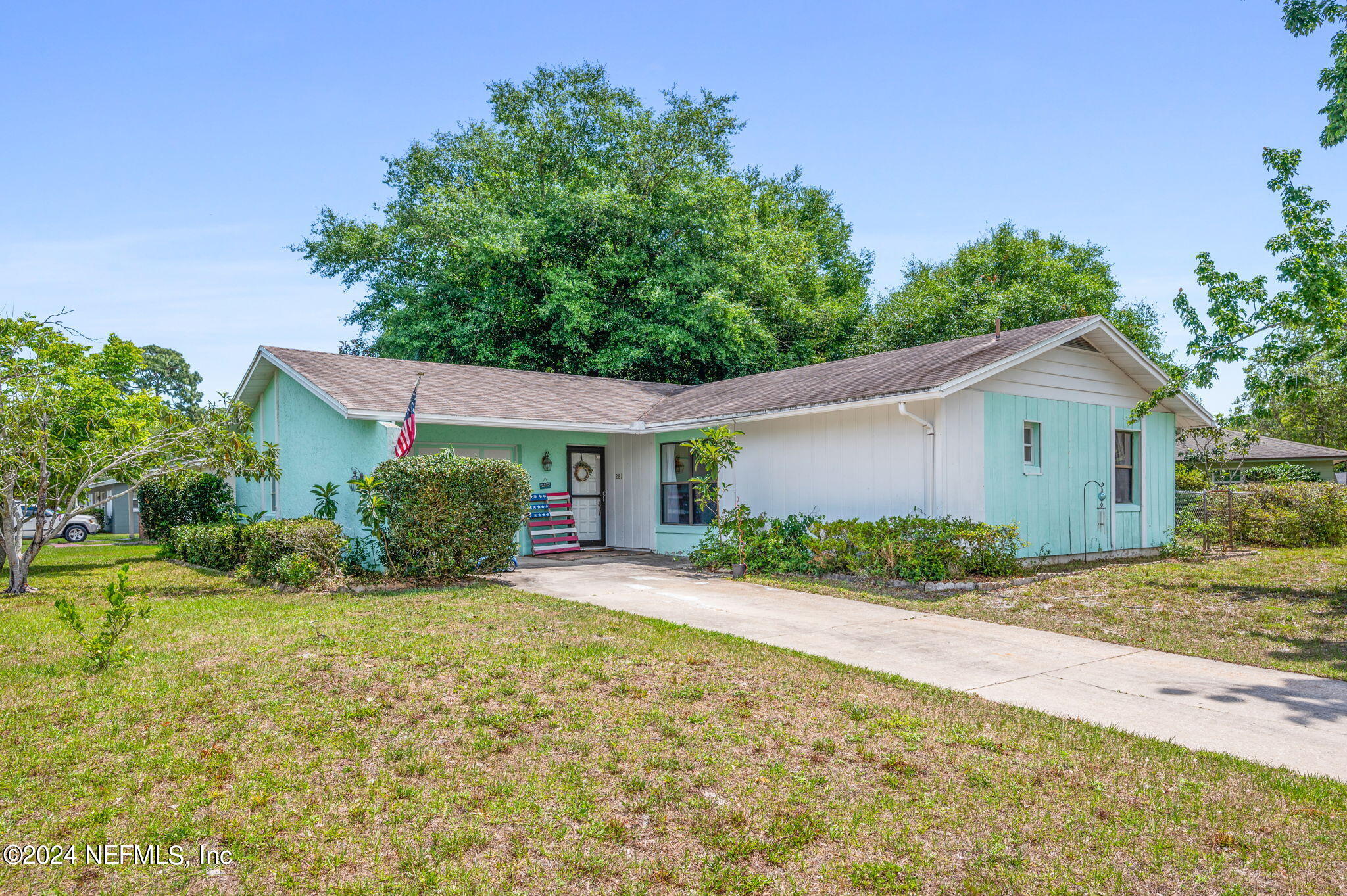 a front view of house with yard and green space