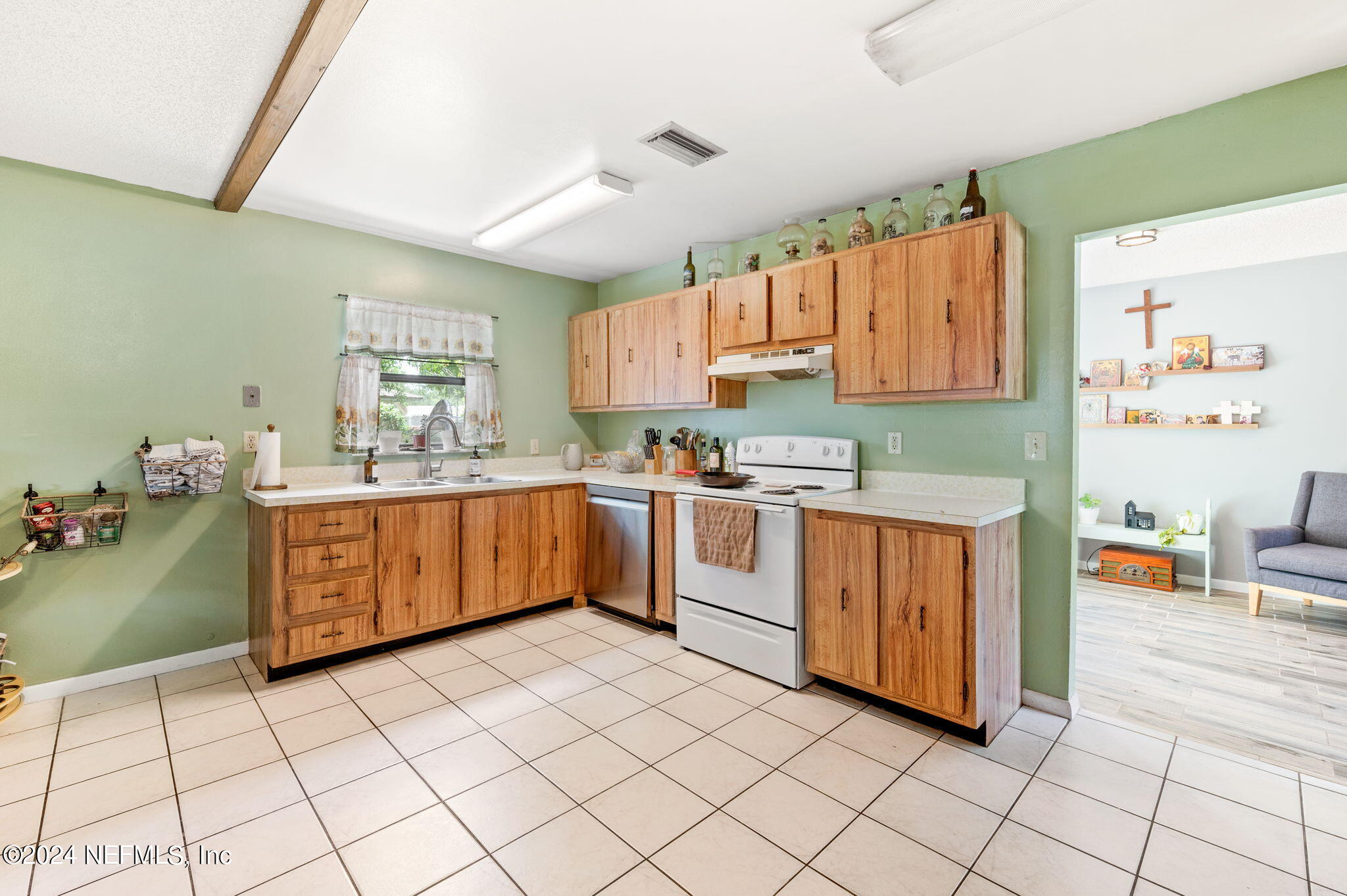 281 Trillo Street St. Augustine, FL 32086 - Photo 14 of 41 a kitchen with a sink a stove top oven cabinets and a window