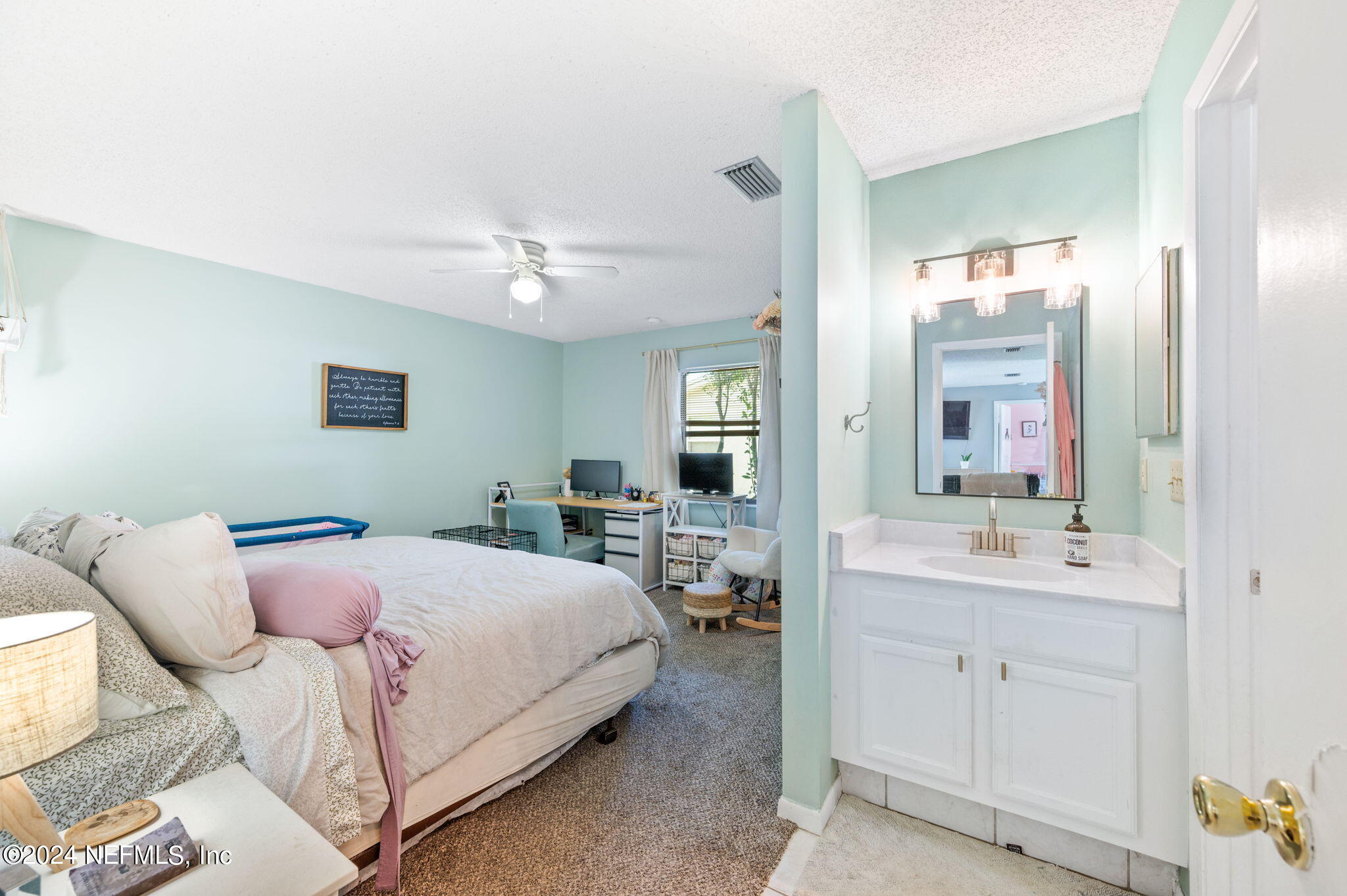 281 Trillo Street St. Augustine, FL 32086 - Photo 28 of 41 a bedroom with a bed and a table