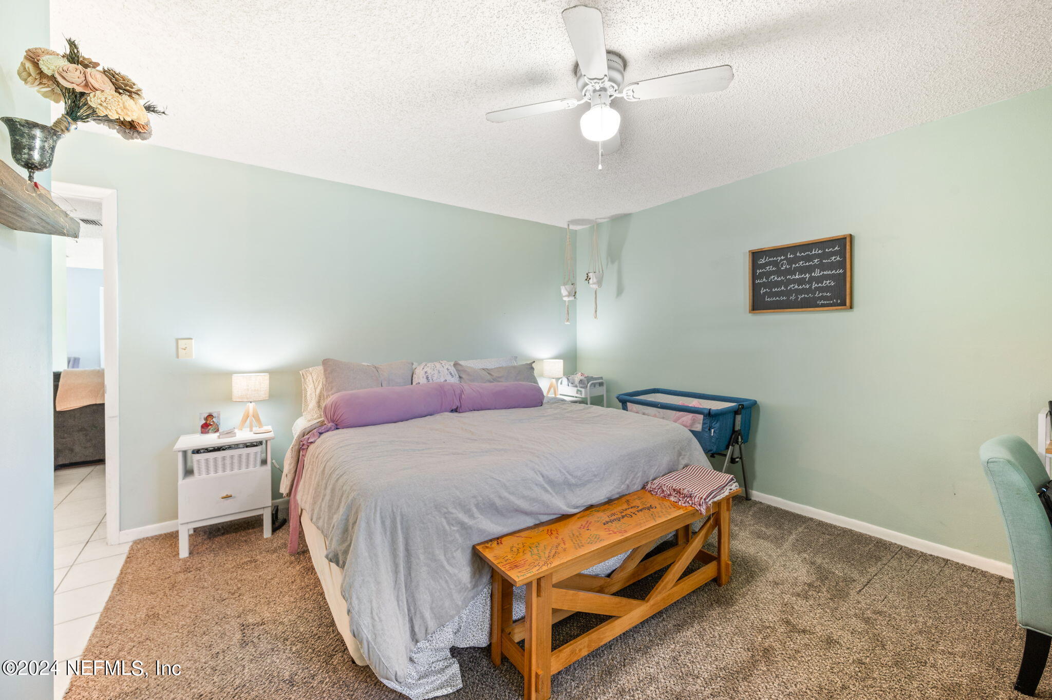 281 Trillo Street St. Augustine, FL 32086 - Photo 31 of 41 a bedroom with a bed and a chandelier