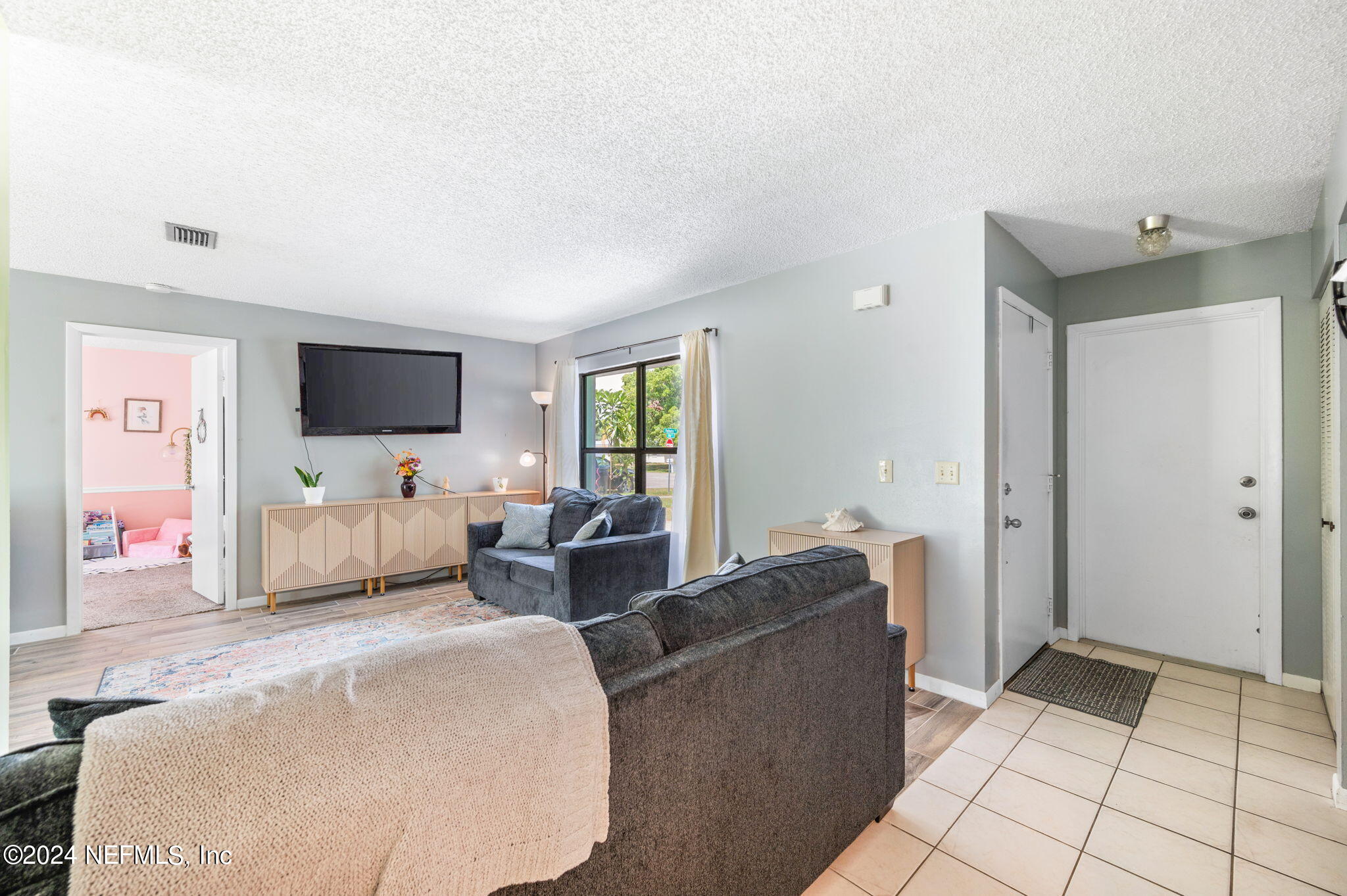 281 Trillo Street St. Augustine, FL 32086 - Photo 8 of 41 a living room with furniture and a flat screen tv