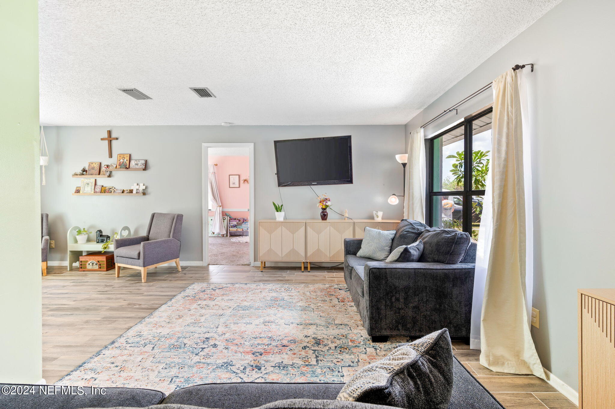 281 Trillo Street St. Augustine, FL 32086 - Photo 10 of 41 a living room with furniture and a flat screen tv