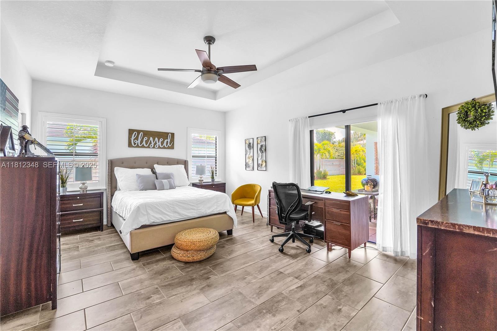 21342 Southwest 132nd Place Miami, FL 33177 - Photo 12 of 16 a bedroom with a bed and a chandelier