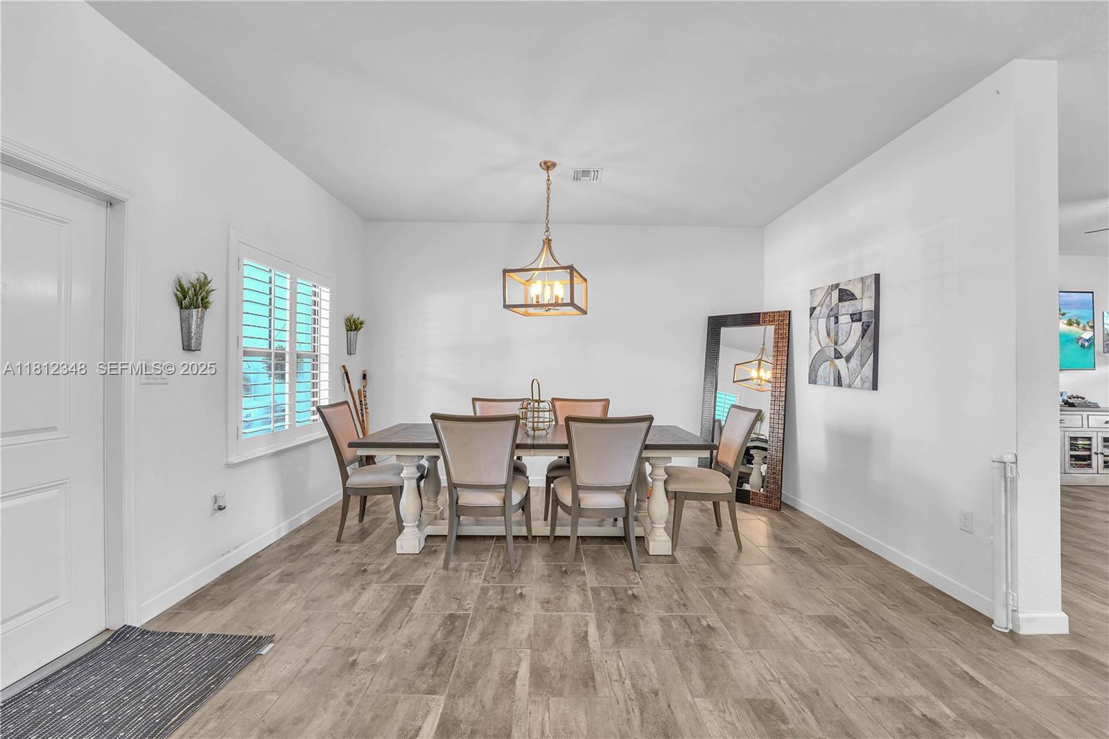 21342 Southwest 132nd Place Miami, FL 33177 - Photo 6 of 16 a view of a dining room with furniture window and wooden floor