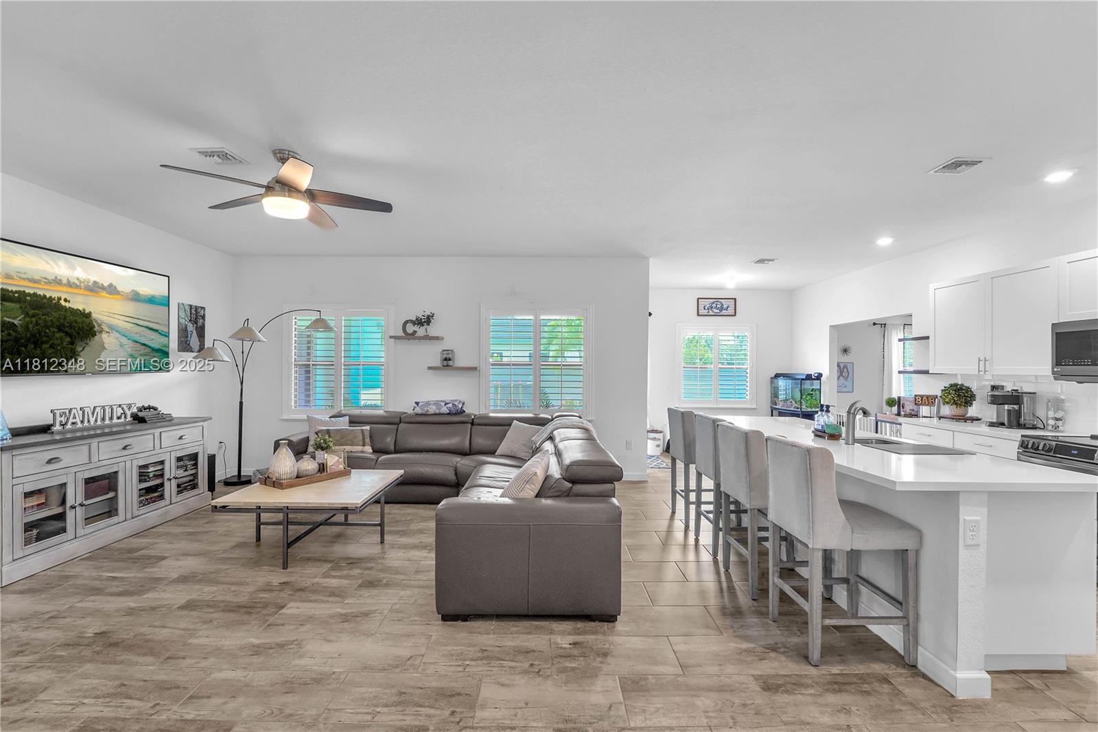 21342 Southwest 132nd Place Miami, FL 33177 - Photo 7 of 16 a living room with furniture and a flat screen tv