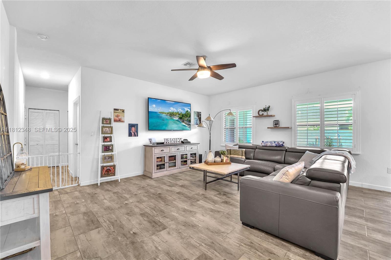 21342 Southwest 132nd Place Miami, FL 33177 - Photo 8 of 16 a living room with furniture and a flat screen tv