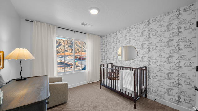 324 North Rhyolite Drive, Unit 87 Hurricane, UT 84737 - Photo 22 of 33 Carpeted bedroom featuring a crib and wallpapered walls
