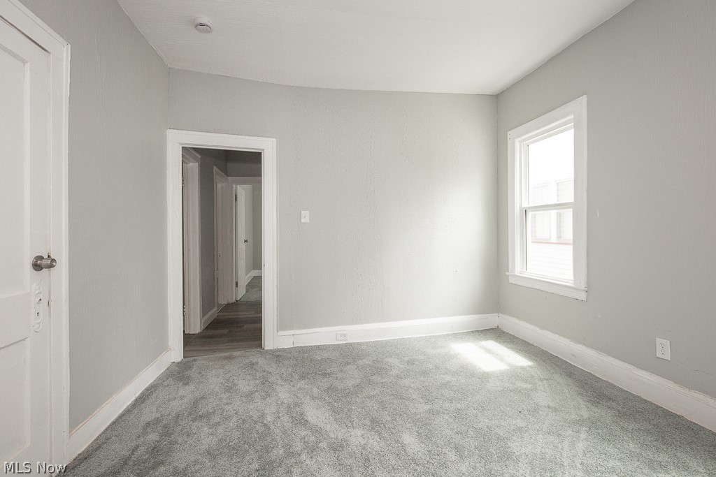 1000 Eddy Road Cleveland, OH 44108 - Photo 17 of 38 Unfurnished bedroom with light carpet and baseboards