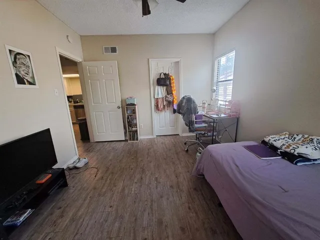 a bedroom with a bed and a flat screen tv