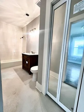 a bathroom with a granite countertop sink toilet and shower view