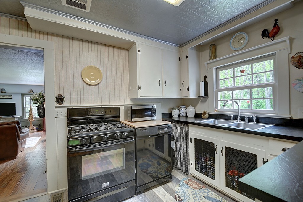 134 Brimfield Road Monson, MA 01057 - Photo 17 of 27 a kitchen with a stove a sink and a microwave