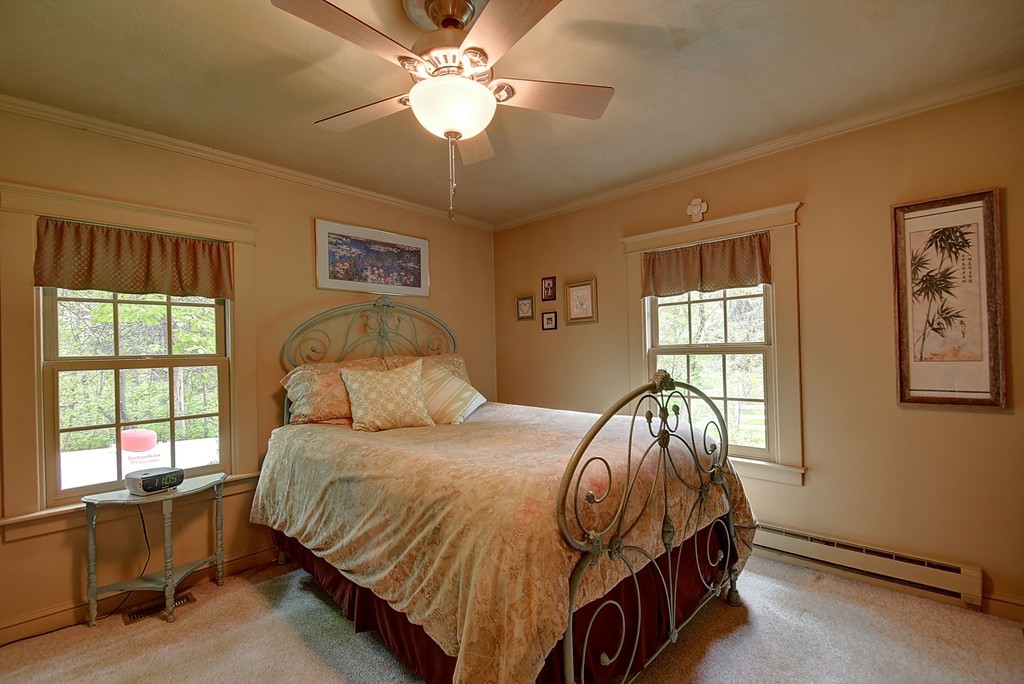 134 Brimfield Road Monson, MA 01057 - Photo 25 of 27 a bedroom with a bed and a chandelier
