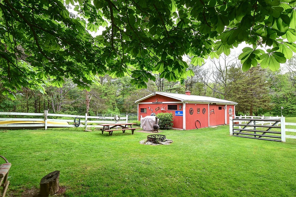 134 Brimfield Road Monson, MA 01057 - Photo 6 of 27 a view of a house with a backyard and a small cabin