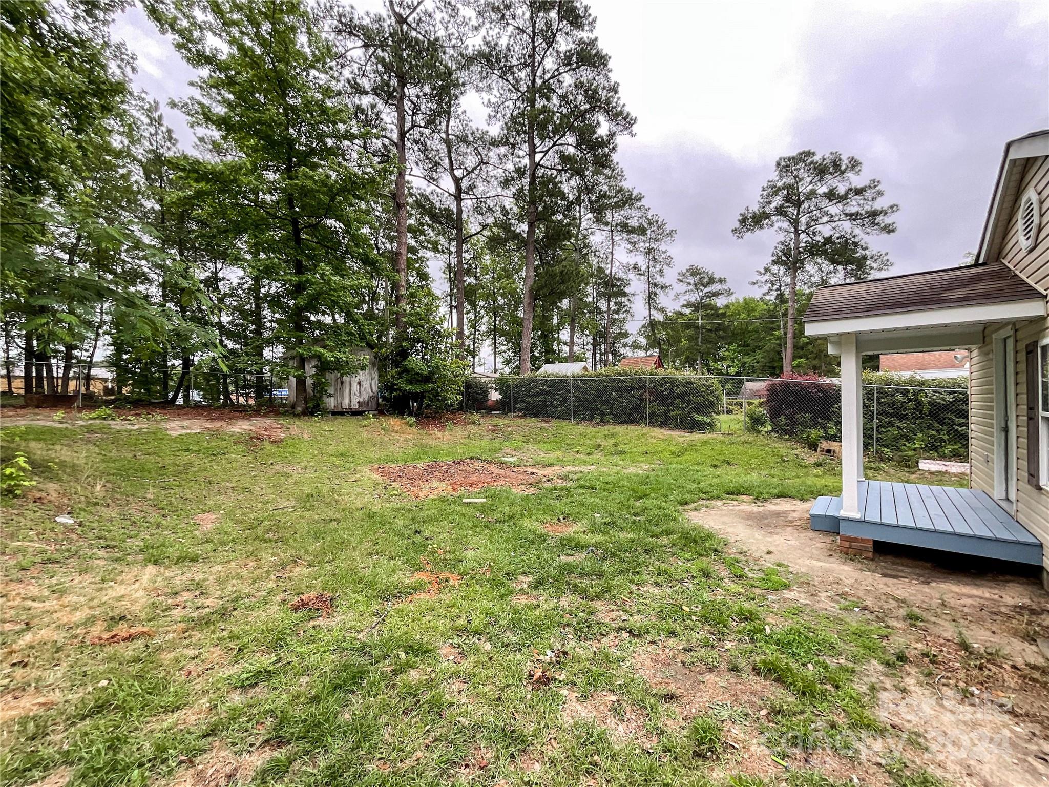 719 Pickett Street Rockingham, NC 28379 - Photo 32 of 36 a view of a garden with a fountain