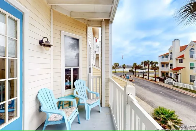a balcony with table and chairs