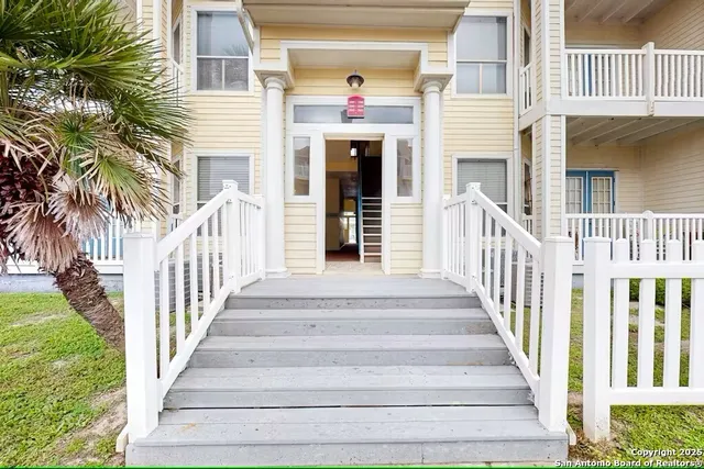 a view of a house with a small deck