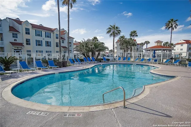 a view of swimming pool with outdoor seating and plants