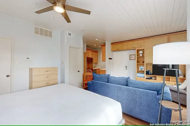 a bedroom with a bed and wooden floor