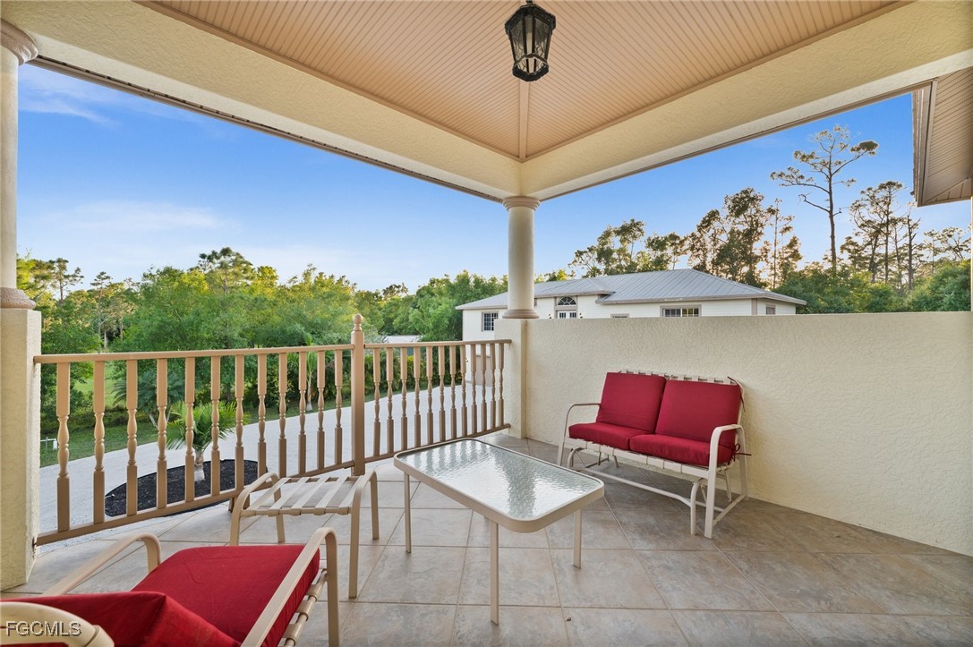 13350 Shetland Lane Fort Myers, FL 33912 - Photo 42 of 49 a balcony with furniture and a potted plant