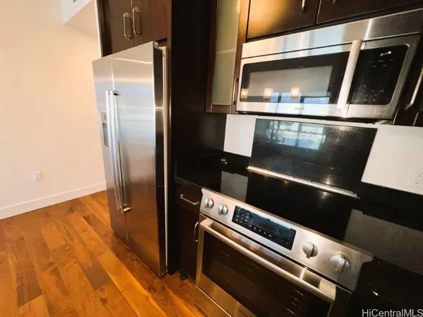 a kitchen with granite countertop a sink and a wooden floor