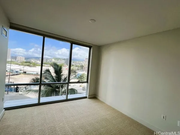 a view of empty room with furniture and window