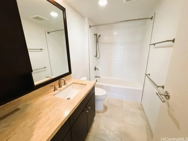 a bathroom with a toilet a sink and a mirror