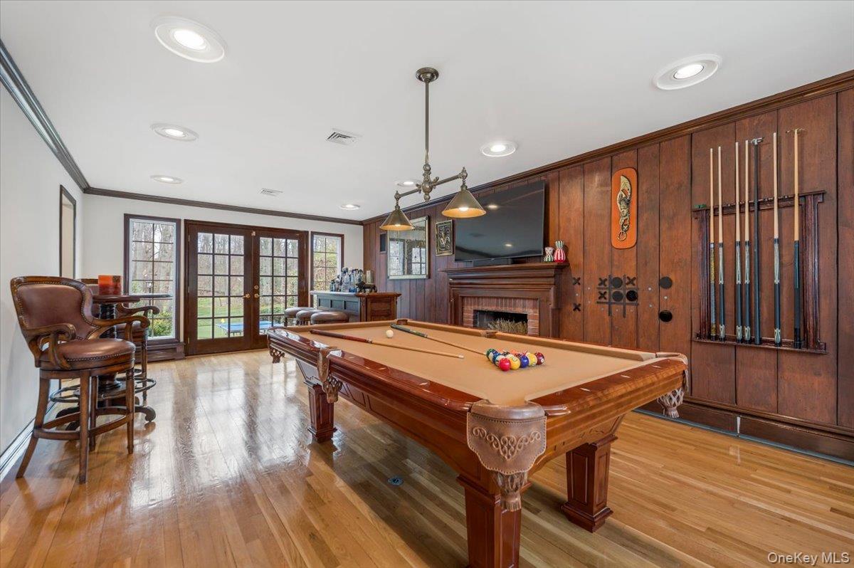 4 Springwood Path Syosset, NY 11791 - Photo 16 of 47 Beautiful hardwood flooring and feature wall with wood paneling. Decorative crown and baseboard moldings and recessed lighting.