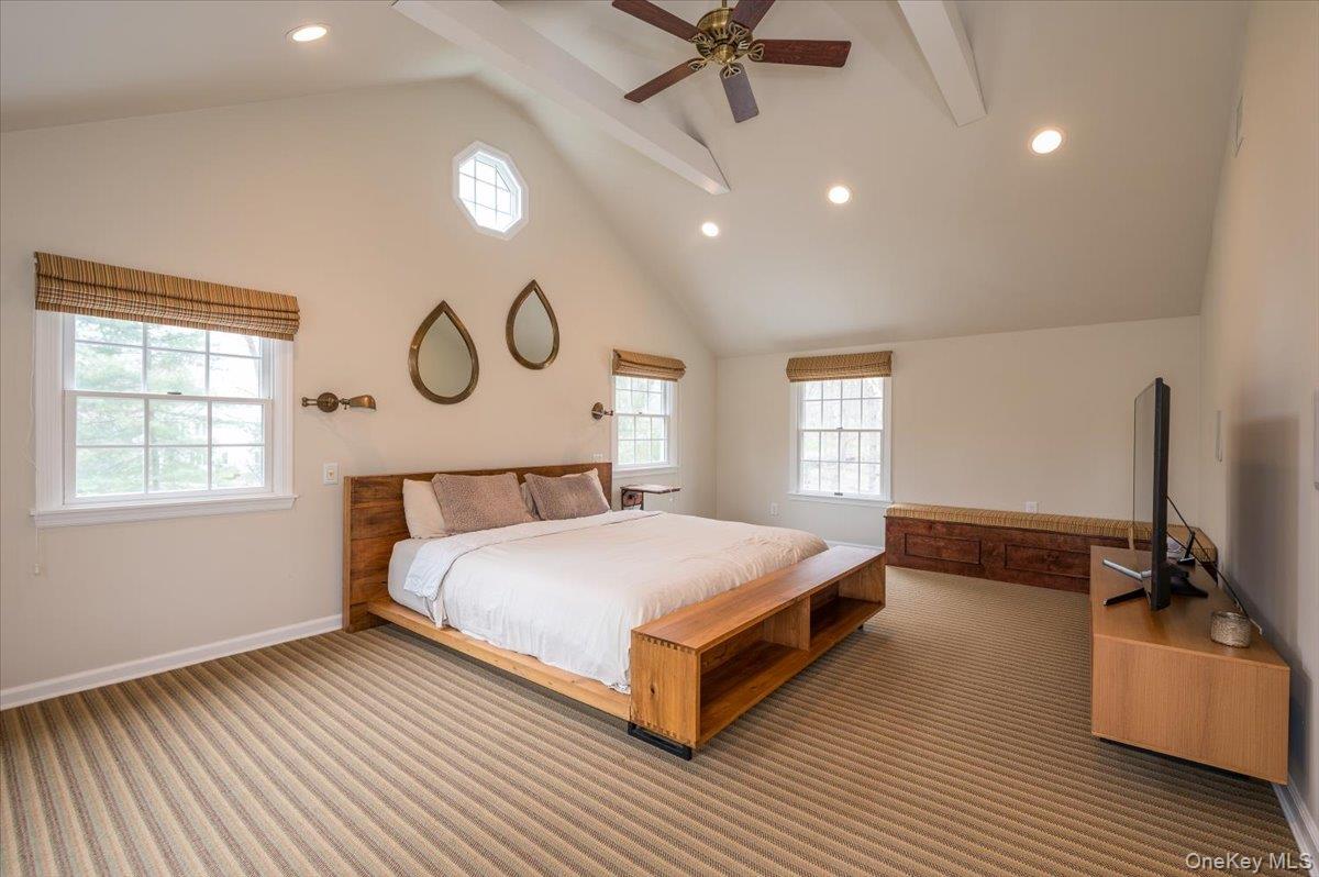 4 Springwood Path Syosset, NY 11791 - Photo 22 of 47 Large space with vaulted ceilings, recessed lighting, ceiling fan, plenty of windows and wall to wall carpeting.