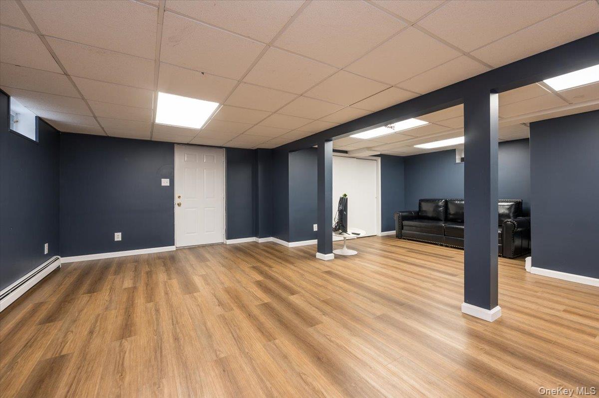 4 Springwood Path Syosset, NY 11791 - Photo 34 of 47 This expansive room features wood-look flooring and a drop ceiling with recessed lighting
