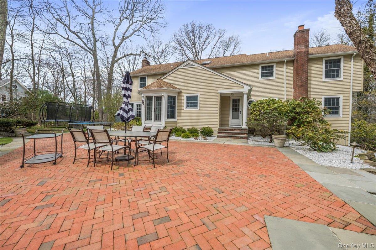 4 Springwood Path Syosset, NY 11791 - Photo 37 of 47 Large brick patio with space for outside dining with direct access to kitchen.