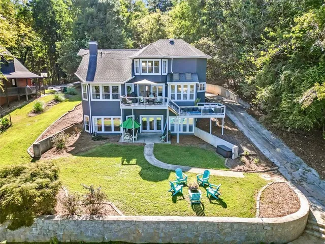 a view of a house with swimming pool and chairs