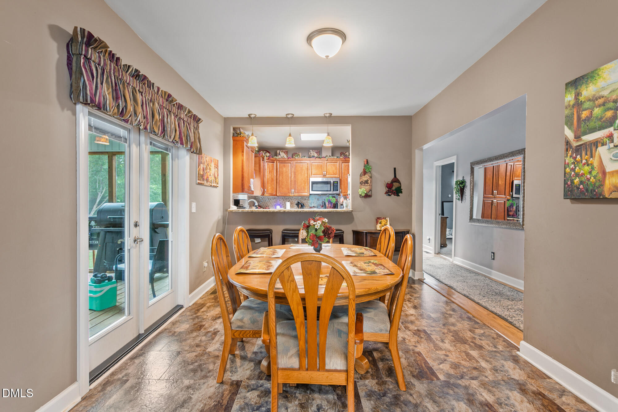 3163 Saul Loop Road Elon, NC 27244 - Photo 9 of 44 a dining room with furniture a chandelier and wooden floor