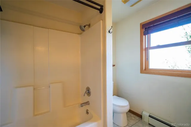a white toilet sitting next to a bathroom sink