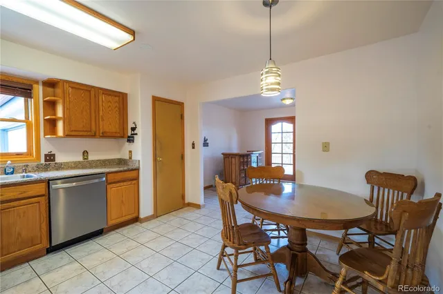 a dining room filled chandelier and wooden floor