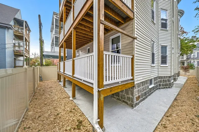 a view of a house with a small deck