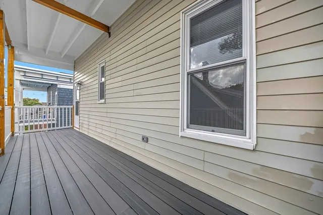 a view of a balcony with wooden floor