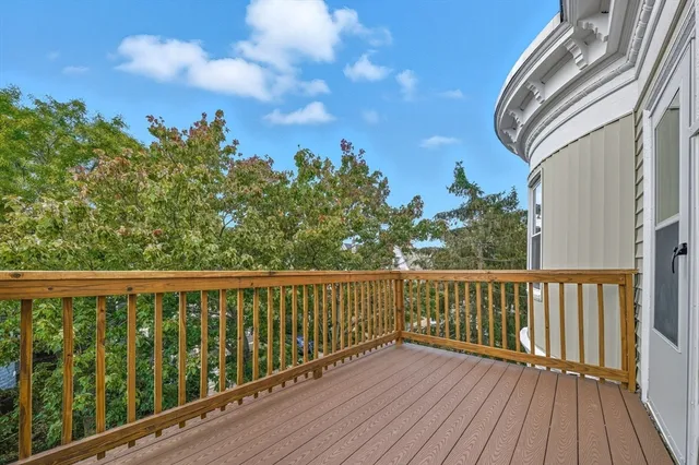 a view of balcony with wooden floor and fence