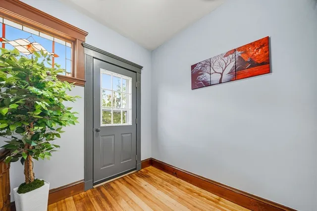a view of an entryway with wooden floor