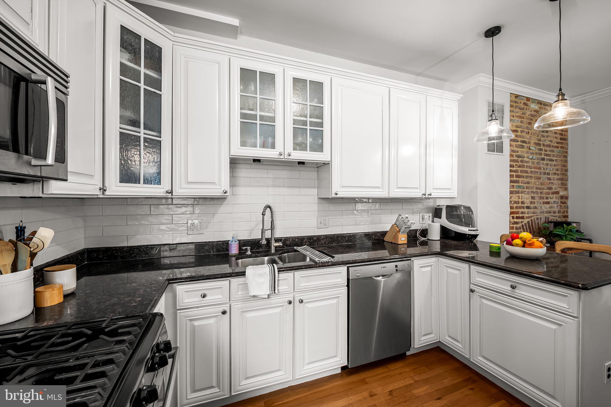 61 East Heath Street Baltimore, MD 21230 - Photo 16 of 30 a kitchen with stainless steel appliances granite countertop a sink a stove and cabinets